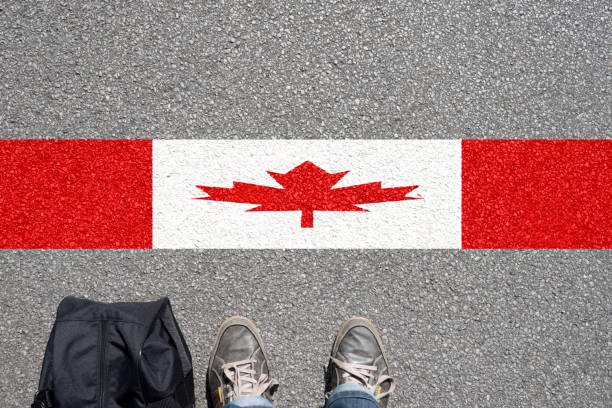 istock A man with a suitcase stands on the border with Cana 970241550