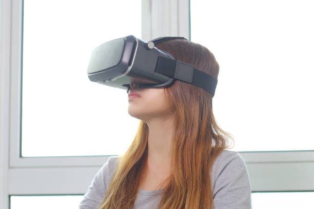 istock Young woman wearing virtual reality glasses at home. 970244104