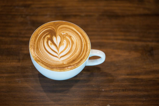 istock Coffee latte art  Selective focus white cup.color vintage style. 970244396
