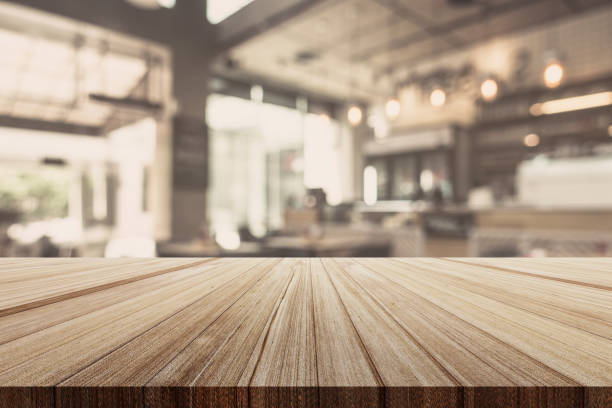 istock wood table top with blur image background of restaurant 970245434