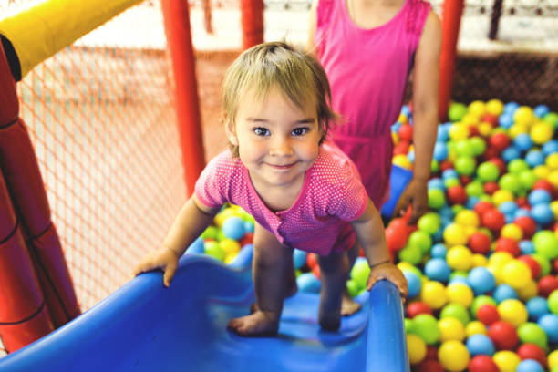 istock Little Girl Playing At Playground Outdoors In Summer 970248734
