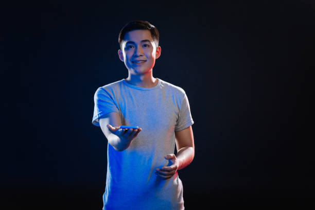 istock Positive joyful man holding his smartphone 970251898
