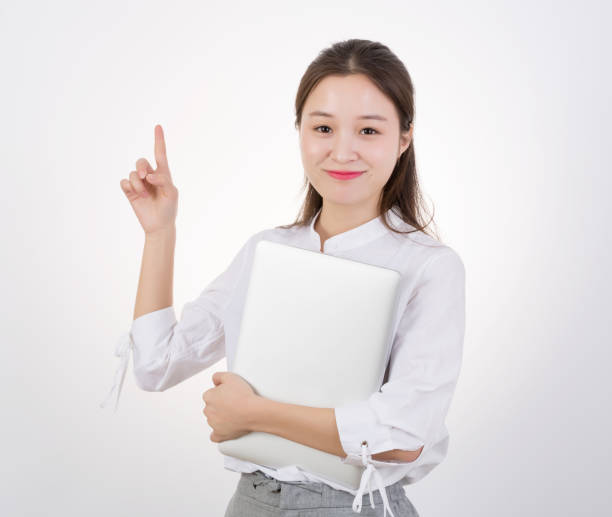 istock Woman Holding Laptop While Pointing Away 970270524