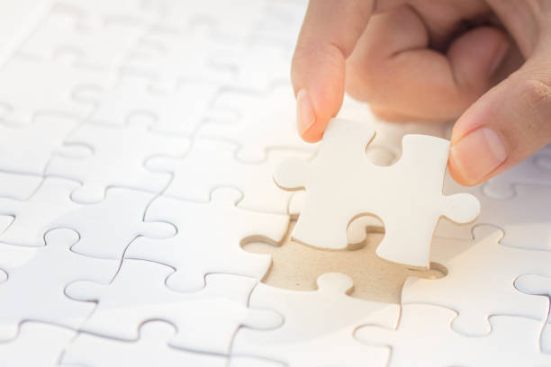 istock Hands put puzzle pieces last jigsaw puzzle, business concept for completing the final puzzle piece,Business Success Concepts 970270890