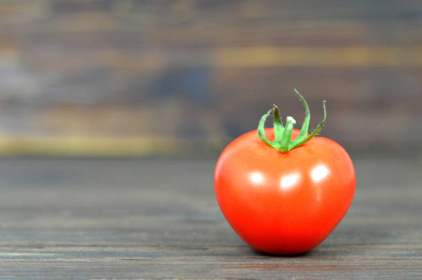 istock Tomato on wooden background 970271084
