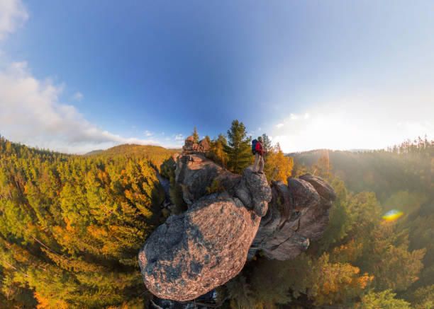 istock Backpacker on top of a rock fall at dawn. Wide angle aerial panorama 970271312