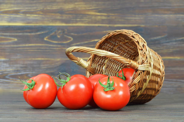 istock Tomatoes in the basket on wooden background 970271952