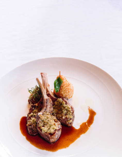istock Grilled lamb chops with crust, gravy and deep fried potato, close up shot 970281450