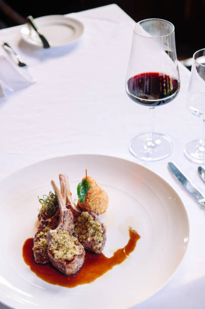 istock Grilled lamb chops with crust, gravy and deep fried potato, dinner table 970281520