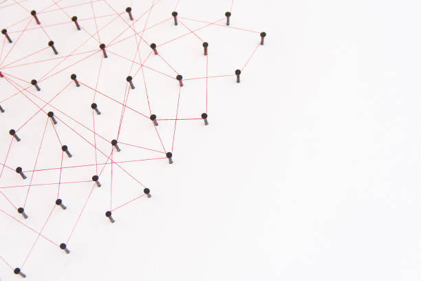 istock Linking entities, social media, Communications Network, The connection between the two networks. Network simulation on white paper linked together with a red thread with copy space 970297534