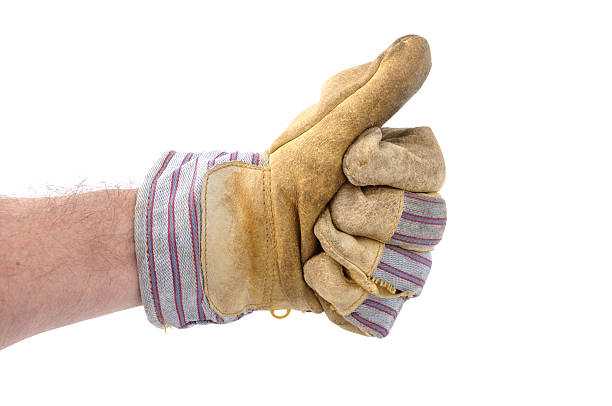 Worker wearing a glove and giving the thumbs up sign stock photo