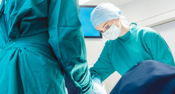 istock Team of surgeons in operation room during surgery 970304964