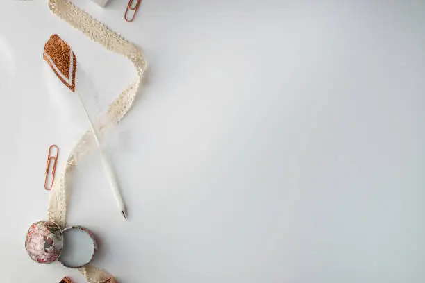 Photo of Rose Gold and Blush Feather Pen and Ribbon Flat Lay Mockup