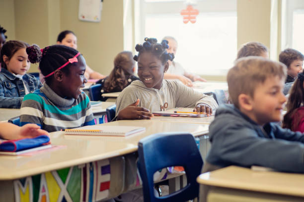 istock Elementary school children taking their places in classroom. 970310614