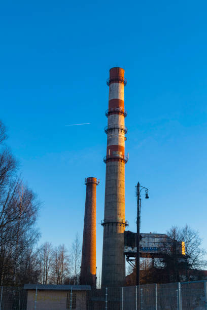 istock Industrial smokestack on sunny day with blue sky and copy space. 970310630