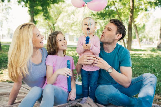 istock Baby girl making soap bubbles with bubble wand 970319224
