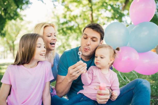 istock Family making foam bubbles with bubble wand 970319900