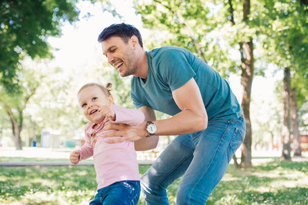 istock Joyful father holding happy daughter 970322470