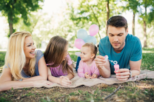 istock Happy family, dad holding bubble wand 970322512