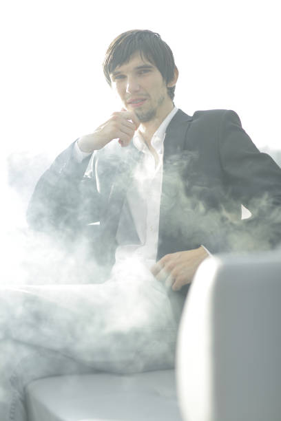 istock close up.businessman with a cigarette during a coffee break 970337818