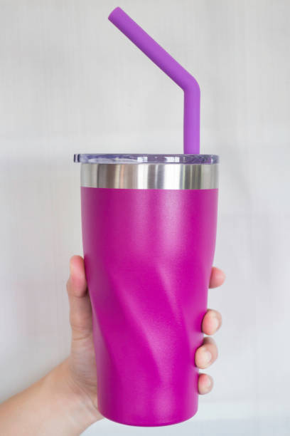 istock Hand on thermos mugs and silicone straw for reusable set 970337902