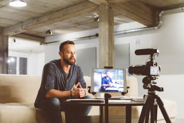 istock Young man making a video blog. 970339140