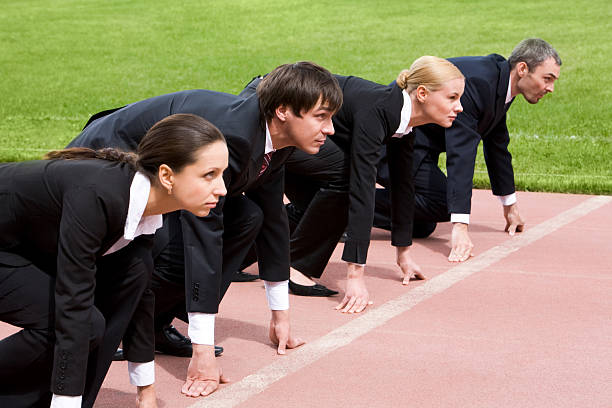 istock Four business professionals lined up at a starting line 97034024