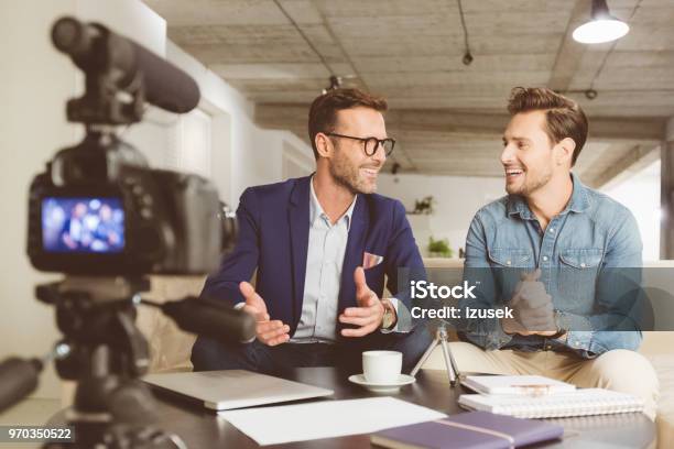Two Men Making A Video Blog Stock Photo - Download Image Now - Interview - Event, Two People, Home Video Camera