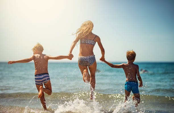 istock Children enjoying splashing in sea 970352400