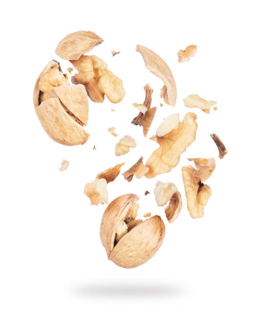 istock Walnuts crushed into pieces close-up on white background 970357434