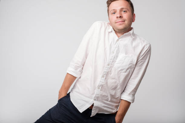 istock Caucasian shy man hiding hands in pockets. 970358230