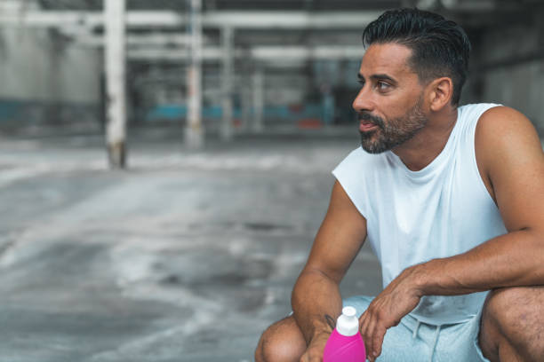 istock Athletic Man Resting after Exercising in an Abandoned Warehouse 970367032