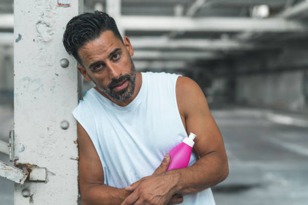 Athletic Man Resting after Exercising in an Abandoned Warehouse