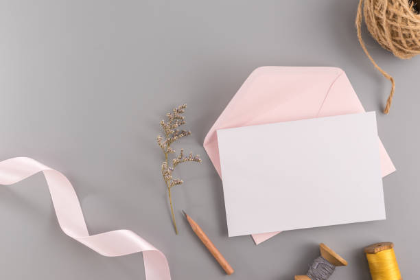 istock A wedding mock up concept. Wedding Invitation, envelopes, cards Papers on grey background with ribbon and decoration. Top view, flat lay, copy space 970367172