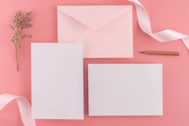 istock A wedding mock up concept. Wedding Invitation, envelopes, cards Papers on pink background with ribbon and decoration. Top view, flat lay, copy space 970367178