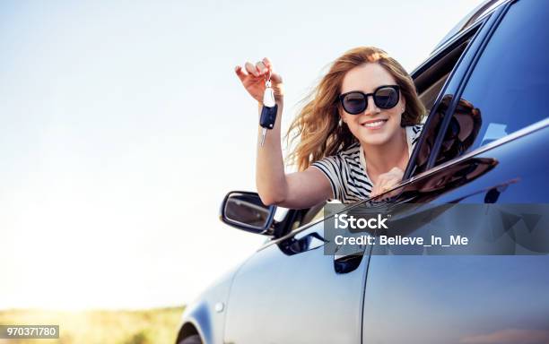 An Attractive Woman In A Car Holds A Car Key In Her Hand Stock Photo - Download Image Now