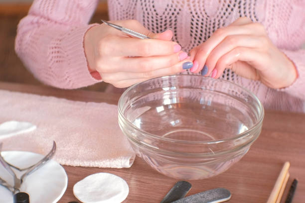 istock Cuticle remover. Woman makes manicure herself. Close-up hands. 970379642