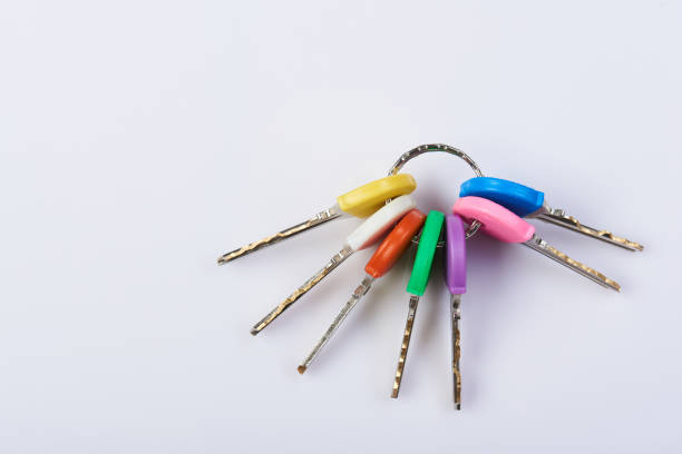 Group of colorful keys on ring isolated on white background close-up