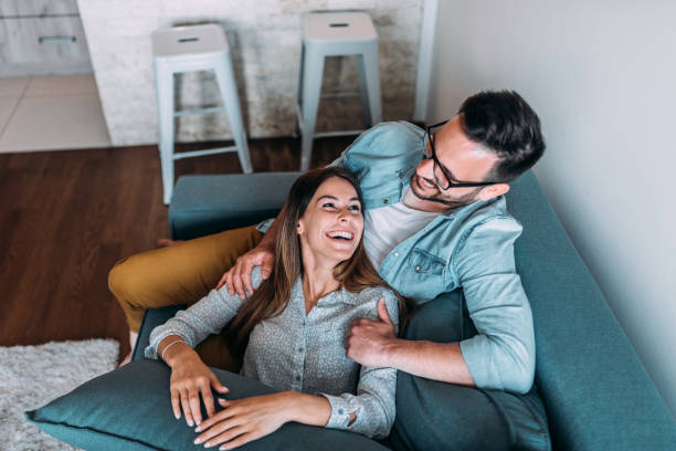 istock Top view of couple relaxing on sofa. 970392004