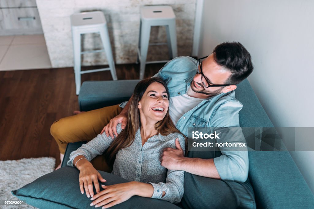 Top view of couple relaxing on sofa. Couple - Relationship Stock Photo