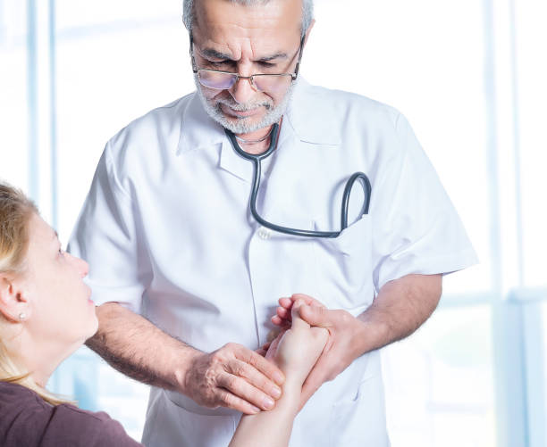 istock Senior Doctor Checking Patient's Heart Rate 970395186