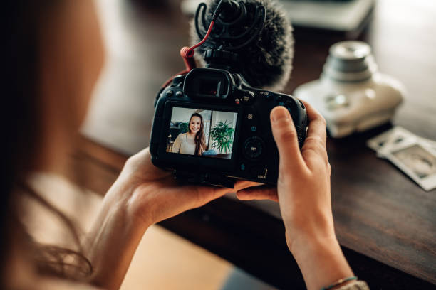 istock Woman blogger looking at her camera 970398248