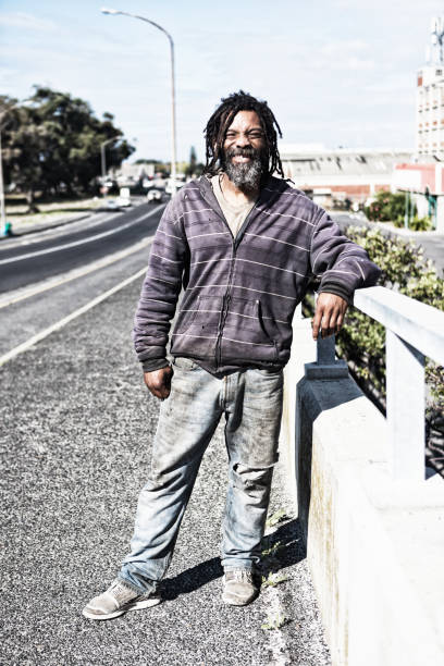 istock Cheerful homeless man leaning on a bridge 970398846