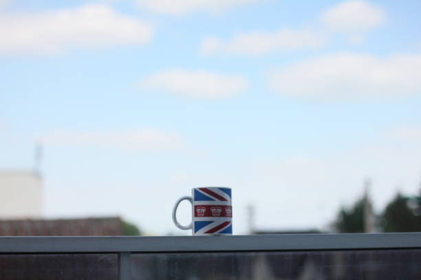 cup on a ledge - photography starbucks flag sign imagens e fotografias de stock