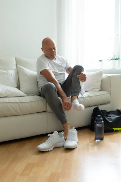 istock Senior man relaxing at home after workout 970408496