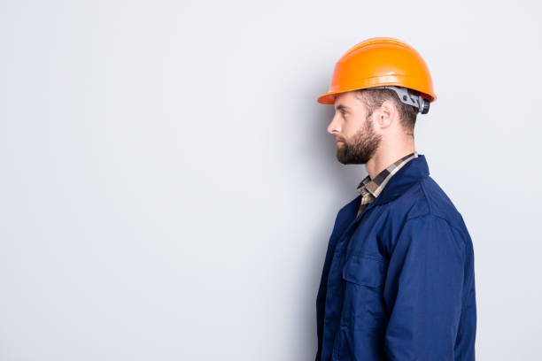 istock Profile side view portrait with copy space, empty place for advertisement product of virile harsh repairer in blue uniform, standing over grey background 970408716