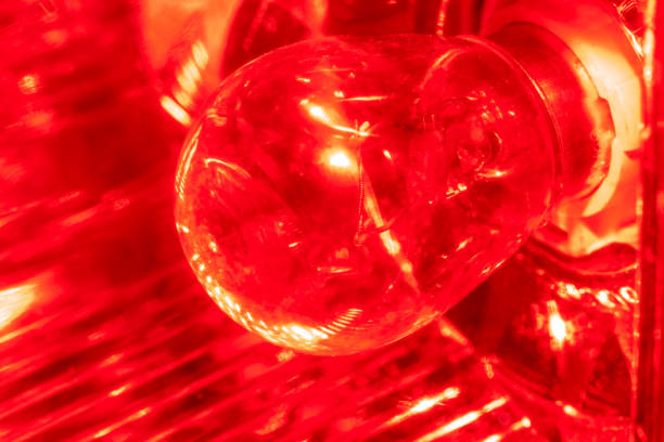 istock High contrast red macro photography texture backgrounds, vehicle reverse light bulb with water drops on 970411982