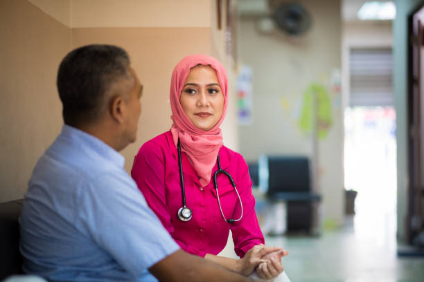 istock Female Muslim Doctor greeting a patient 970412792