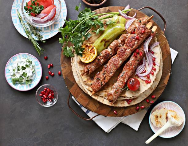 Kebab. Kebab. Traditional middle eastern, arabic or mediterranean  meat kebab with vegetables and herbs. Overhead view, copy space kebab photos stock pictures, royalty-free photos & images