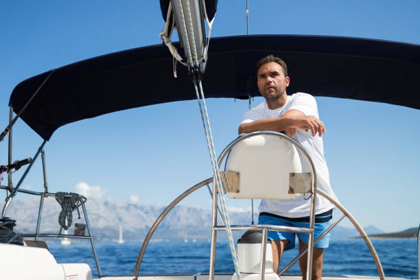 istock Happy smiling man sailing with his yacht 970417202